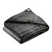 A folded black and grey chevron patterned tarp with white on the reverse side.
