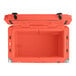 A coral CaterGator outdoor cooler with the lid open and black handles.
