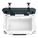 A white cooler with black handles.