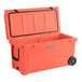 A coral CaterGator outdoor cooler with wheels.