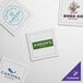 A close-up of a white single-use beverage napkin with a square logo design for Aaron's.