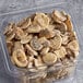 A plastic container of Phillips Gourmet Mushrooms IQF Seasoned Sautéed Roasted Sliced White Mushrooms.