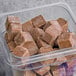 A plastic container filled with brown Live Pure Chocolate Peanut Butter protein smoothie cubes.