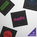 A black square Choice dinner napkin with white and red text.