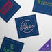 A navy blue single-use Choice dinner napkin with a green logo.