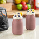 A blender with Live Pure Acai Blend smoothie cubes in it on a counter.