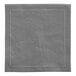 A gray cloth napkin with white stitching.