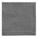 A close-up of a gray cotton cloth napkin with white stitching.