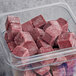 A plastic container on a counter filled with red Live Pure Acai Tropical Boost frozen smoothie cubes.