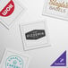 A group of white square single-use cotton dinner napkins with brown text.