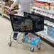 A man pushing a Regency black plastic grocery cart.