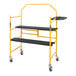 A yellow Metaltech folding scaffolding with black shelves and safety rails.