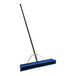 A Lavex polypropylene push broom with a blue and black metal handle.