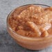 A bowl of Les Vergers Boiron quince fruit puree on a table.