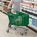 A man pushing a green Regency grocery cart.