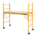 A yellow Metaltech portable baker scaffolding with wheels.