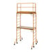 A Metaltech portable scaffolding tower with guardrail and shelves.