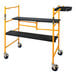 A yellow and black Metaltech folding scaffolding cart with wheels.