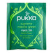 A green Pukka package of Supreme Matcha Green Tea bags with white text and green leaves.