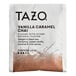 A white Tazo packet with black and brown text containing Tazo Vanilla Caramel Chai tea bags.