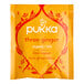 A yellow Pukka Organic Three Ginger tea bag packet with red and white text.