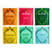 A variety pack of Pukka organic tea bags in green, blue, pink, and yellow packaging with white and black text.