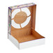 A white cardboard box with a Mardi Gras design including a white circle on the top.