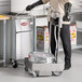 A man in a chef's uniform using a MirOil fryer oil filter machine in a professional kitchen.