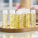 A tray of small PAYA Papaya shower gel bottles with yellow labels.