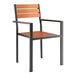 A Lancaster Table & Seating outdoor chair with a black frame and brown faux teak slat seat.