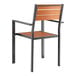 A Lancaster Table & Seating outdoor chair with a brown faux teak slat seat and wood back and armrests on a black metal frame.