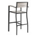 A black Lancaster Table & Seating outdoor barstool with a gray faux teak slat seat and arms.