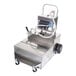A stainless steel filtration machine with hoses and wheels.