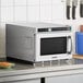 A Solwave stainless steel commercial microwave oven on a counter.