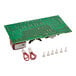 A Noble Warewashing control board with a green circuit board and red and white wire connectors.