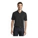 A man wearing a black Port Authority polo shirt.