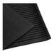 A black rubber livestock mat with an amoebic pattern top, measuring 4 feet by 6 feet and 1/2 inch thick.