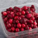 A plastic container of Wyman's whole cranberries.