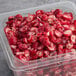 A plastic container of Wyman's frozen sliced cranberries.