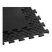 A set of black interlocking rubber gym floor mats with a textured surface and grid-patterned underside.