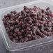 A plastic container of Wyman's Frozen Wild Blueberries.