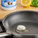 A frying pan with melted LouAna Coconut Oil, lemon, and garlic.
