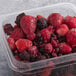 A white plastic container of Wyman's frozen mixed berries.