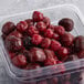 A plastic container of Wyman's frozen cherries.