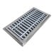 A stainless steel floor trough grate with metal bars.