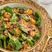 A bowl of salad with White Toque quinoa, spinach, and cranberries.