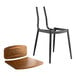 A black Lancaster Table & Seating mid-century chair with vintage wood seat and backrest.