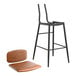 A black Lancaster Table & Seating barstool with a brown padded seat and backrest.