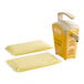 A yellow Heinz countertop pump dispenser with two yellow and white Heinz Honey Mustard pouches.