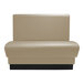 A tan leather booth with black base.